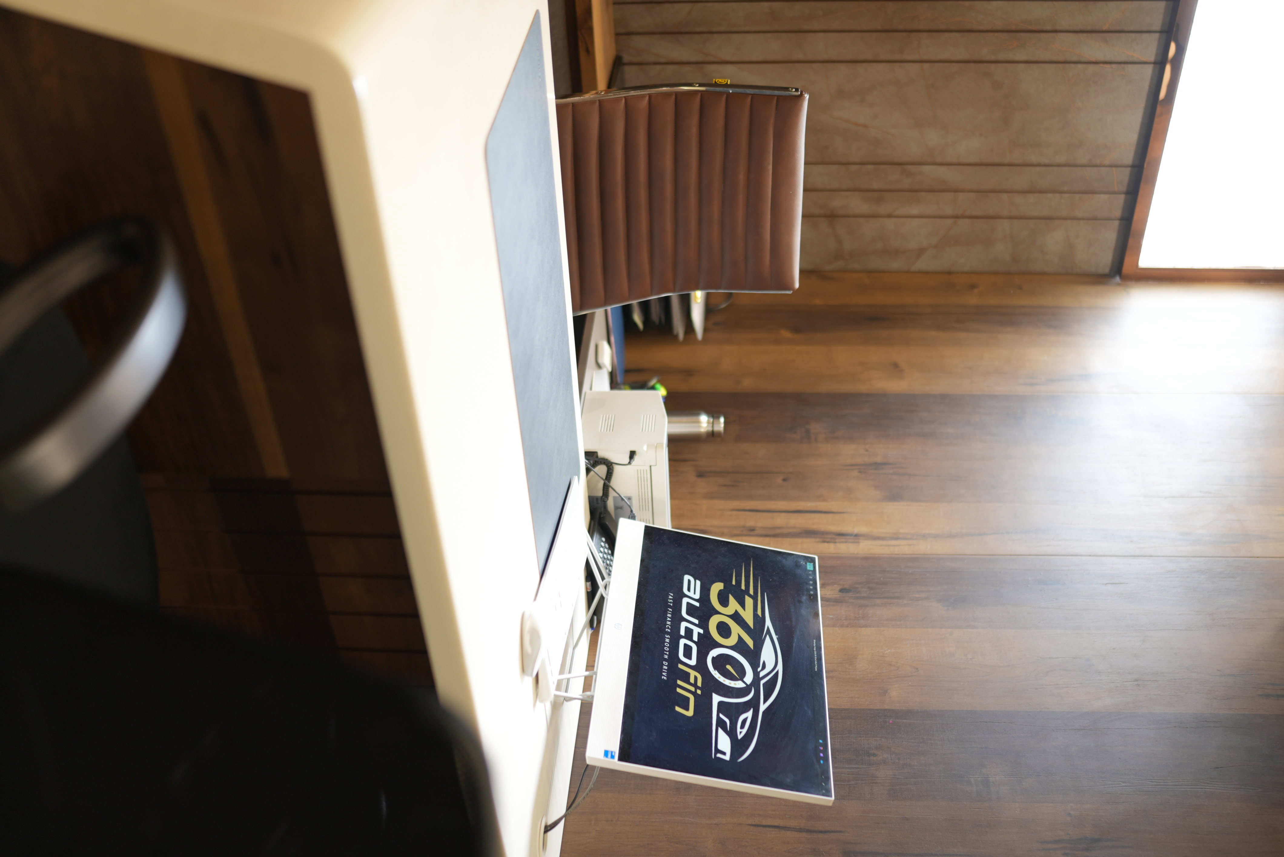 360 AutoFin office desk with brand logo on screen